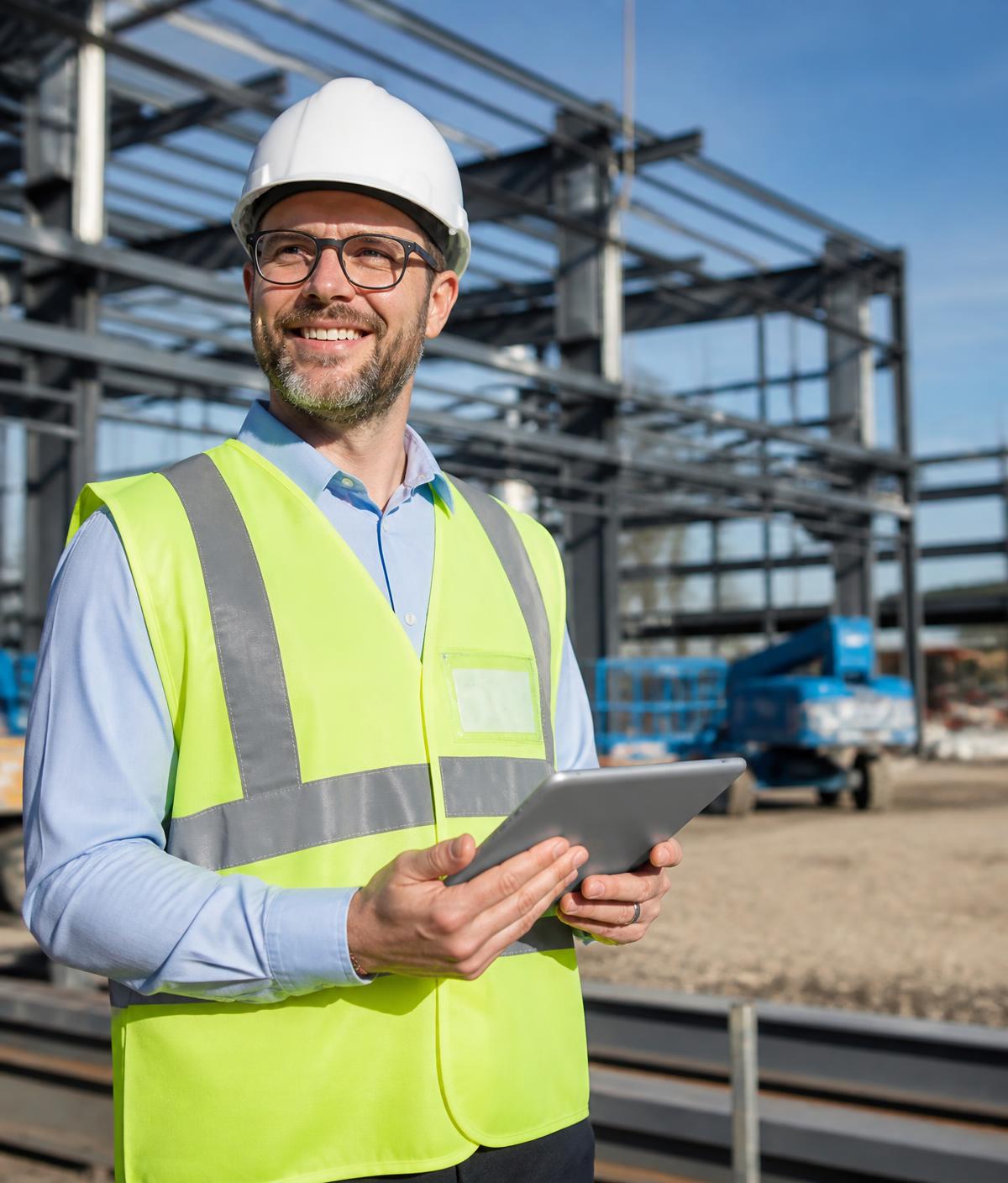 Construction leader reviewing project plans on site